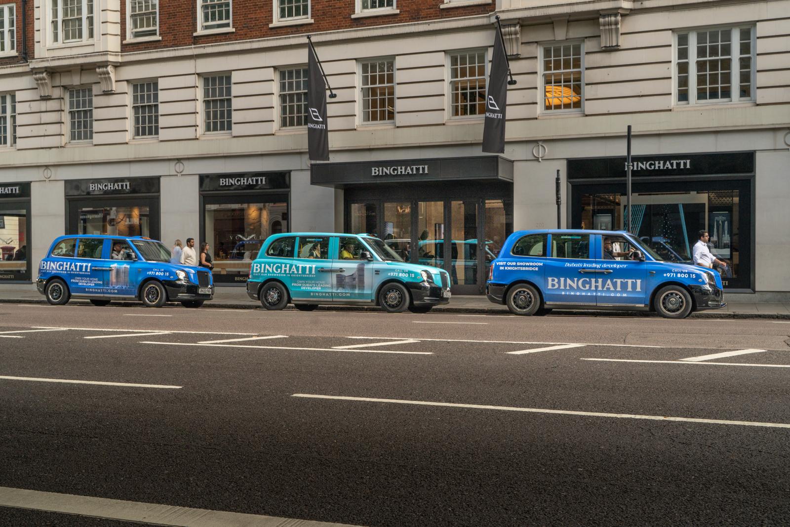 London black cabs wrapped in full-livery client advertising on a Knightsbridge street